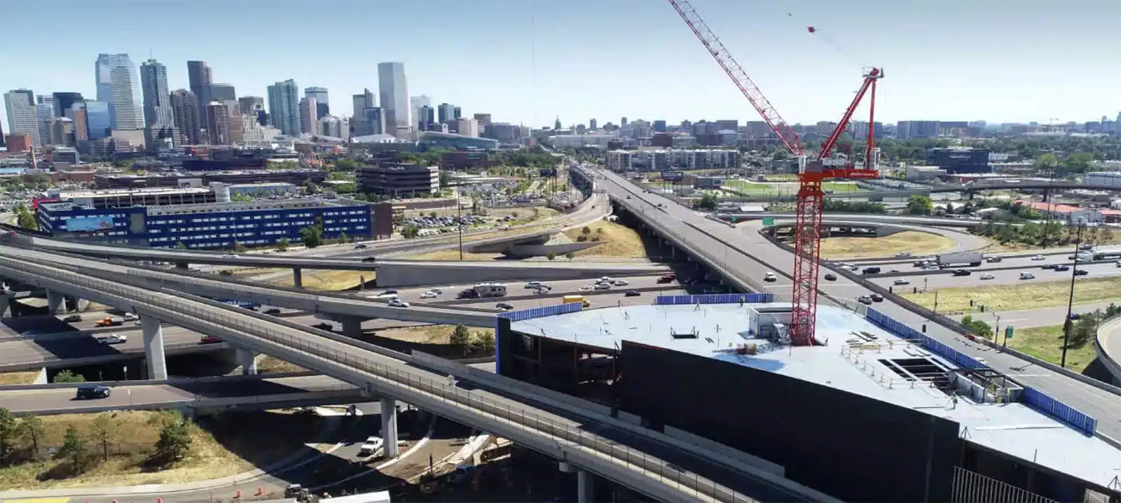 Urban skyline with highways and construction crane